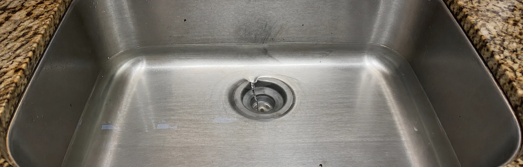 water backing up in shower drain Murfreesboro plumber inspecting